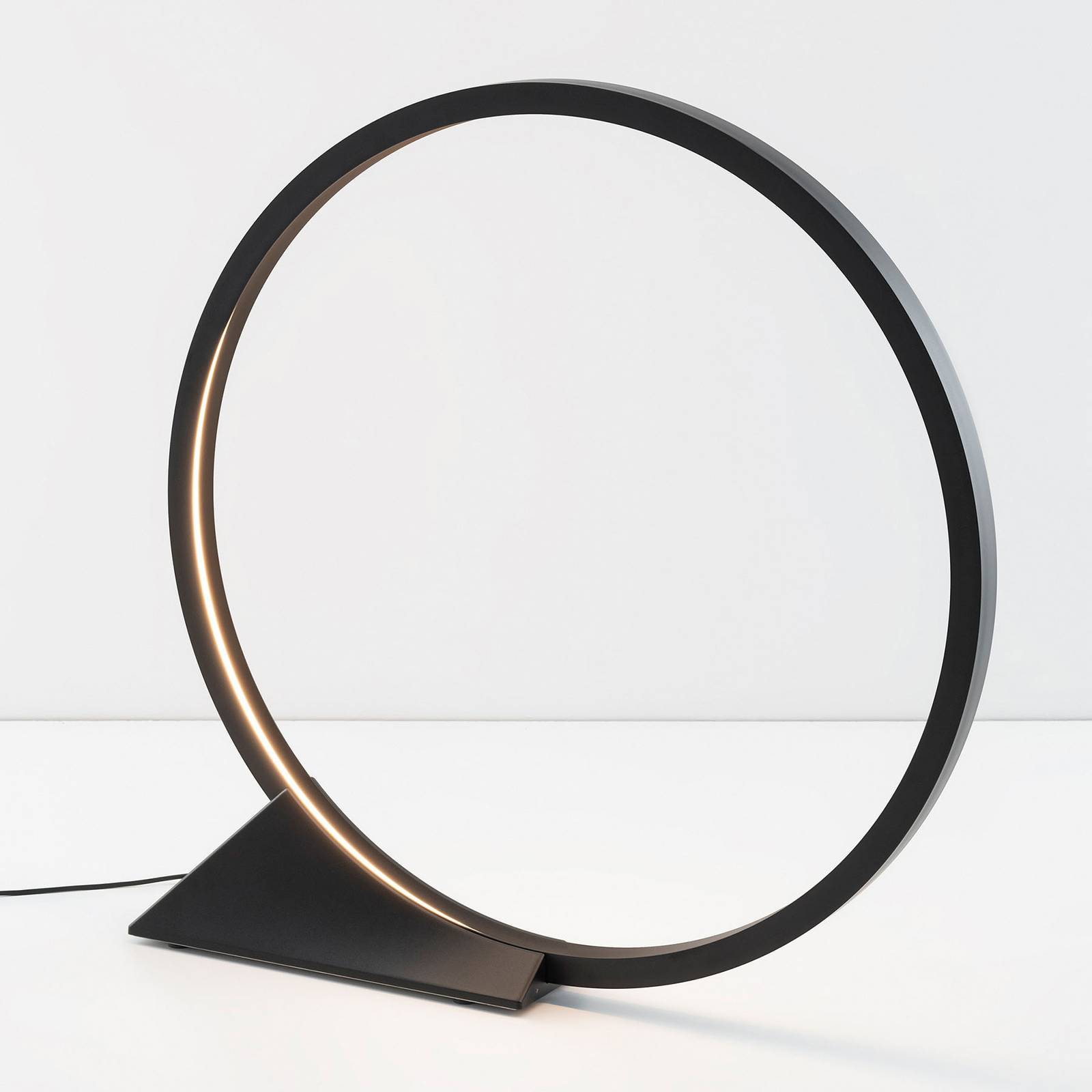 Lampadaire LED Artemide O noir à anneau lumineux diffusant une lumière blanche chaude — vue 2